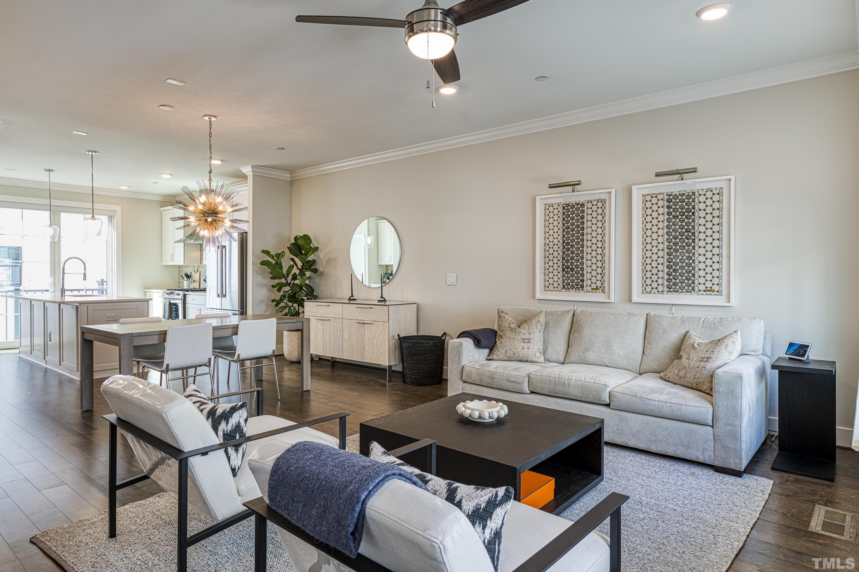 401 Bryan Pointe Drive, Unit 103 Raleigh, NC 27608 - Photo 20 of 33 a living room with furniture a rug and a chandelier