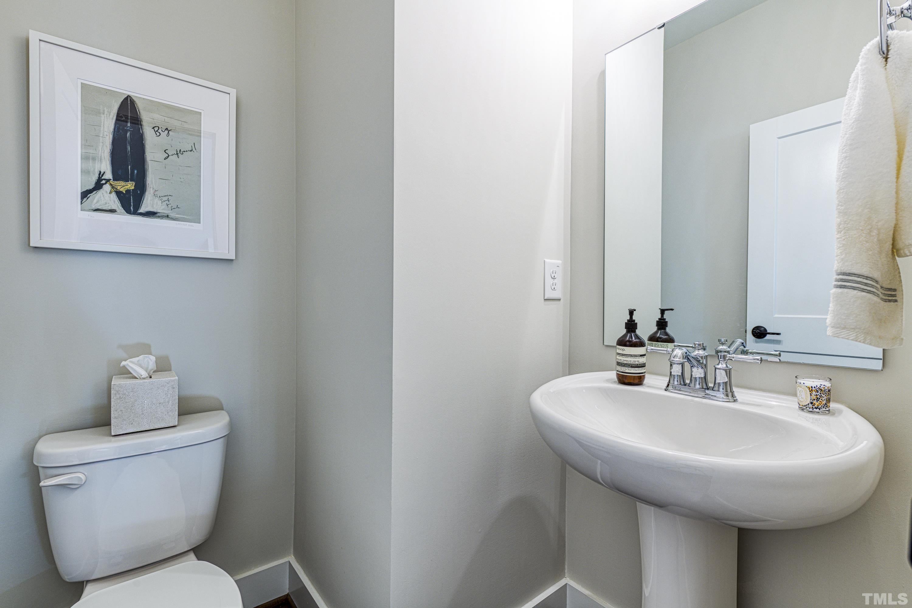 401 Bryan Pointe Drive, Unit 103 Raleigh, NC 27608 - Photo 23 of 33 a bathroom with a toilet a sink and a mirror