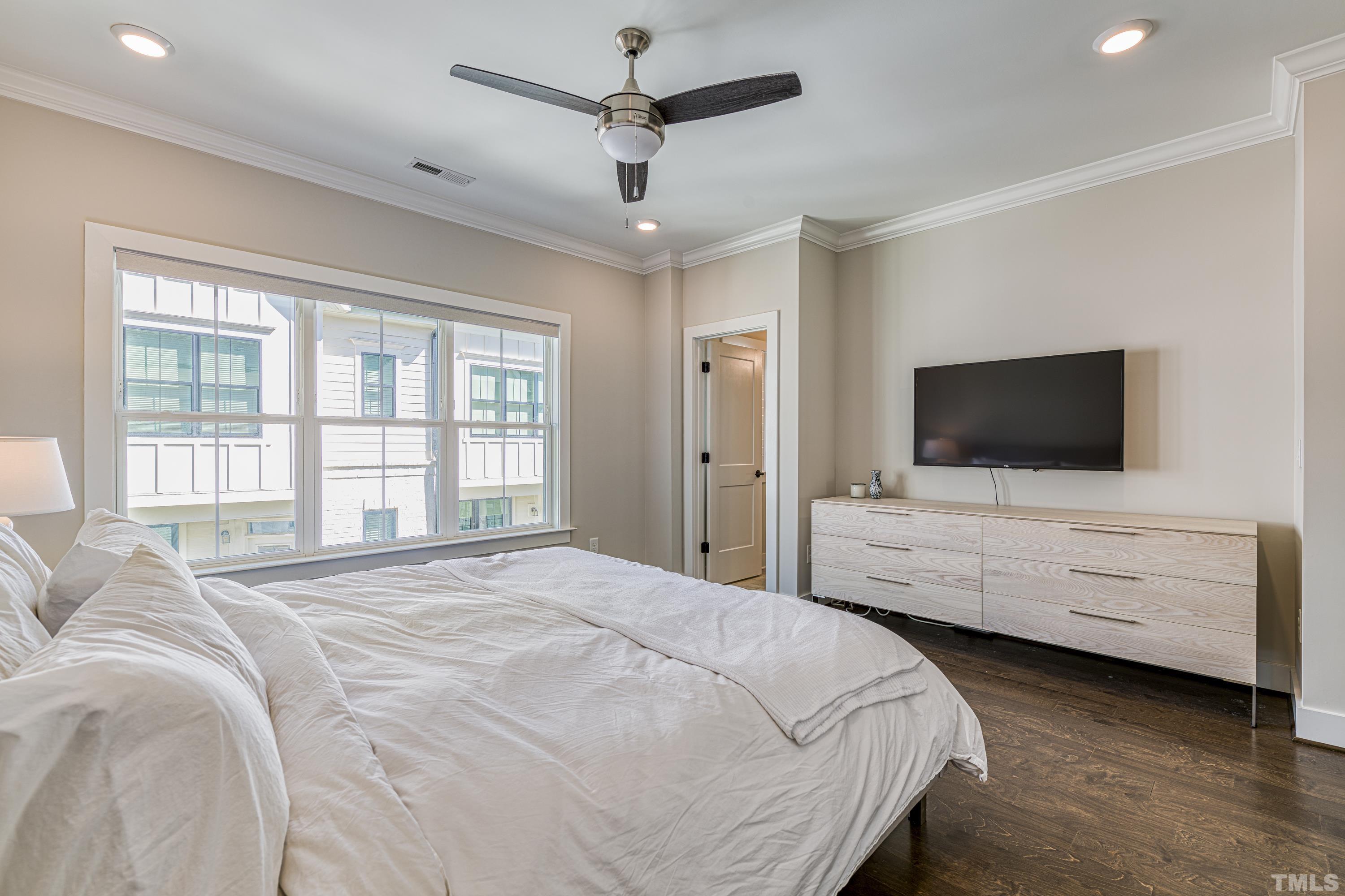 401 Bryan Pointe Drive, Unit 103 Raleigh, NC 27608 - Photo 26 of 33 a bedroom with a bed flat screen tv and window