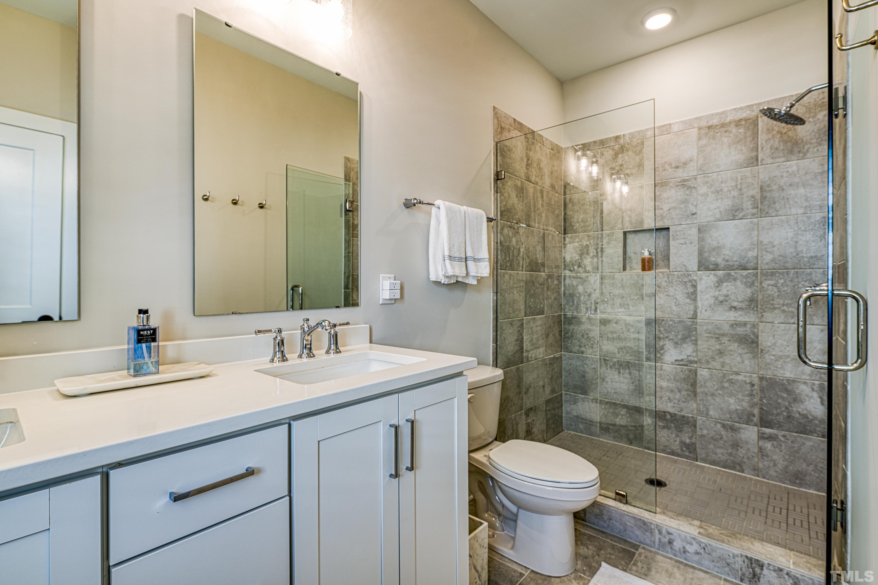401 Bryan Pointe Drive, Unit 103 Raleigh, NC 27608 - Photo 28 of 33 a bathroom with a sink toilet and shower