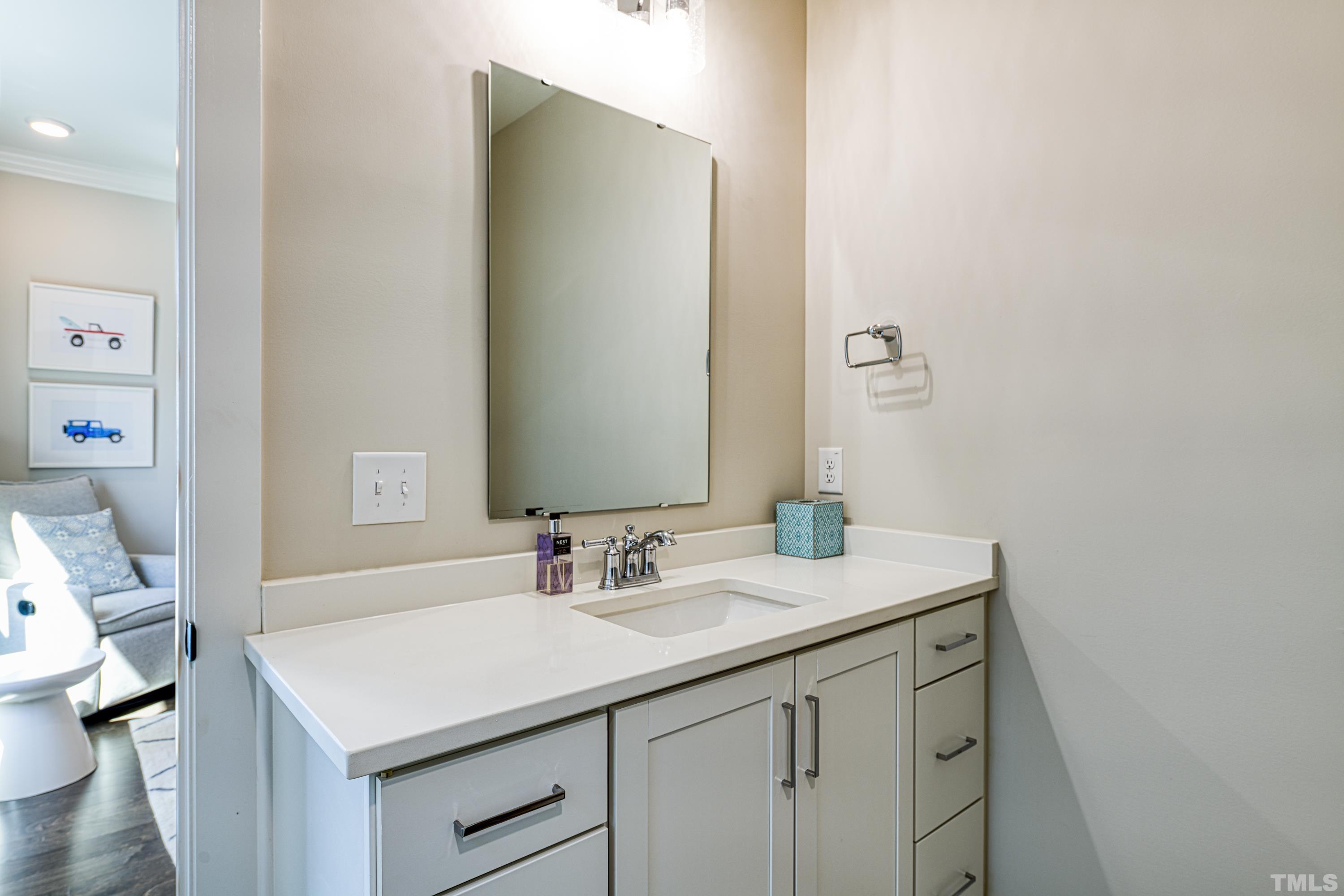 401 Bryan Pointe Drive, Unit 103 Raleigh, NC 27608 - Photo 31 of 33 a bathroom with a sink vanity and a mirror