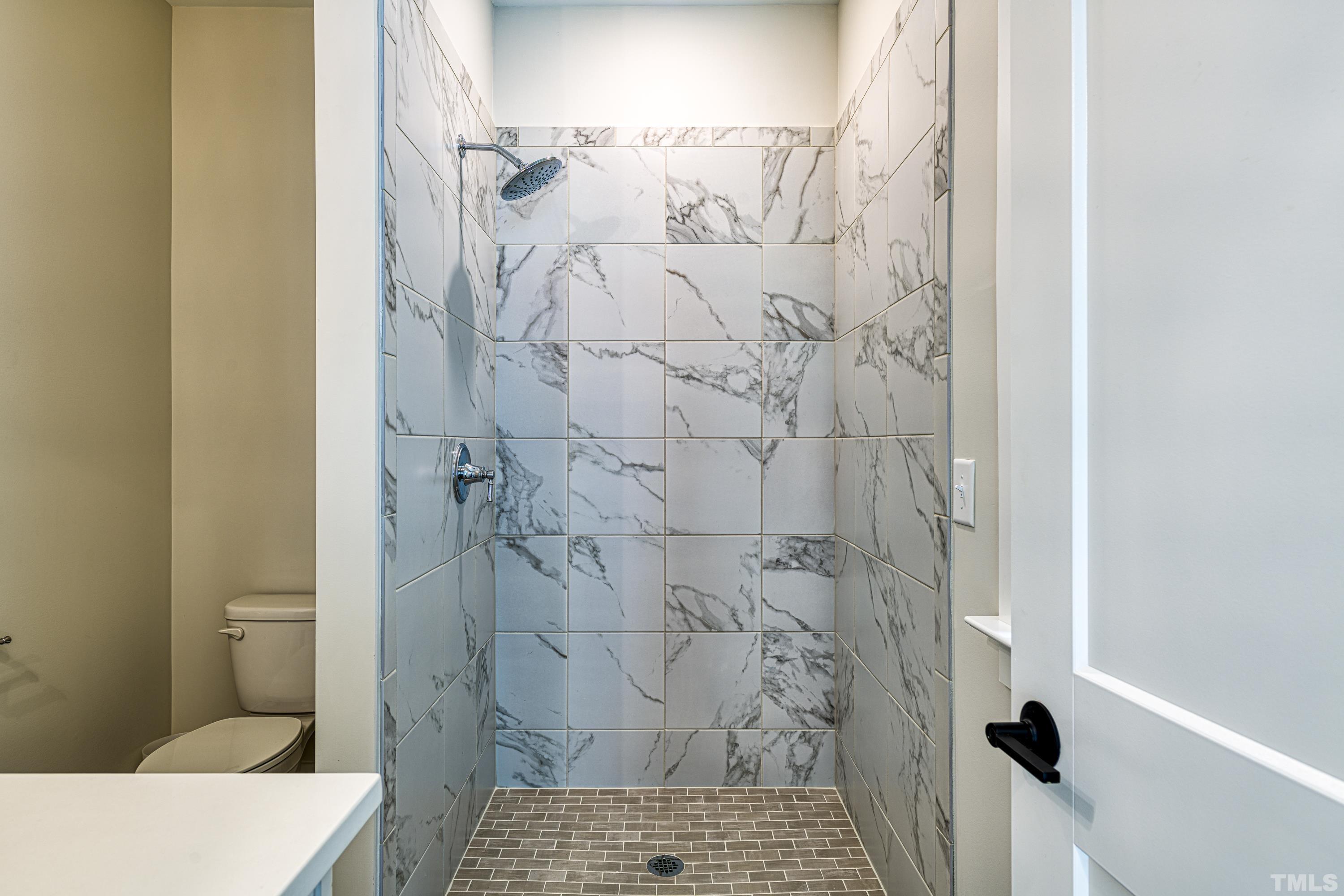 401 Bryan Pointe Drive, Unit 103 Raleigh, NC 27608 - Photo 32 of 33 a bathroom with a toilet and a shower