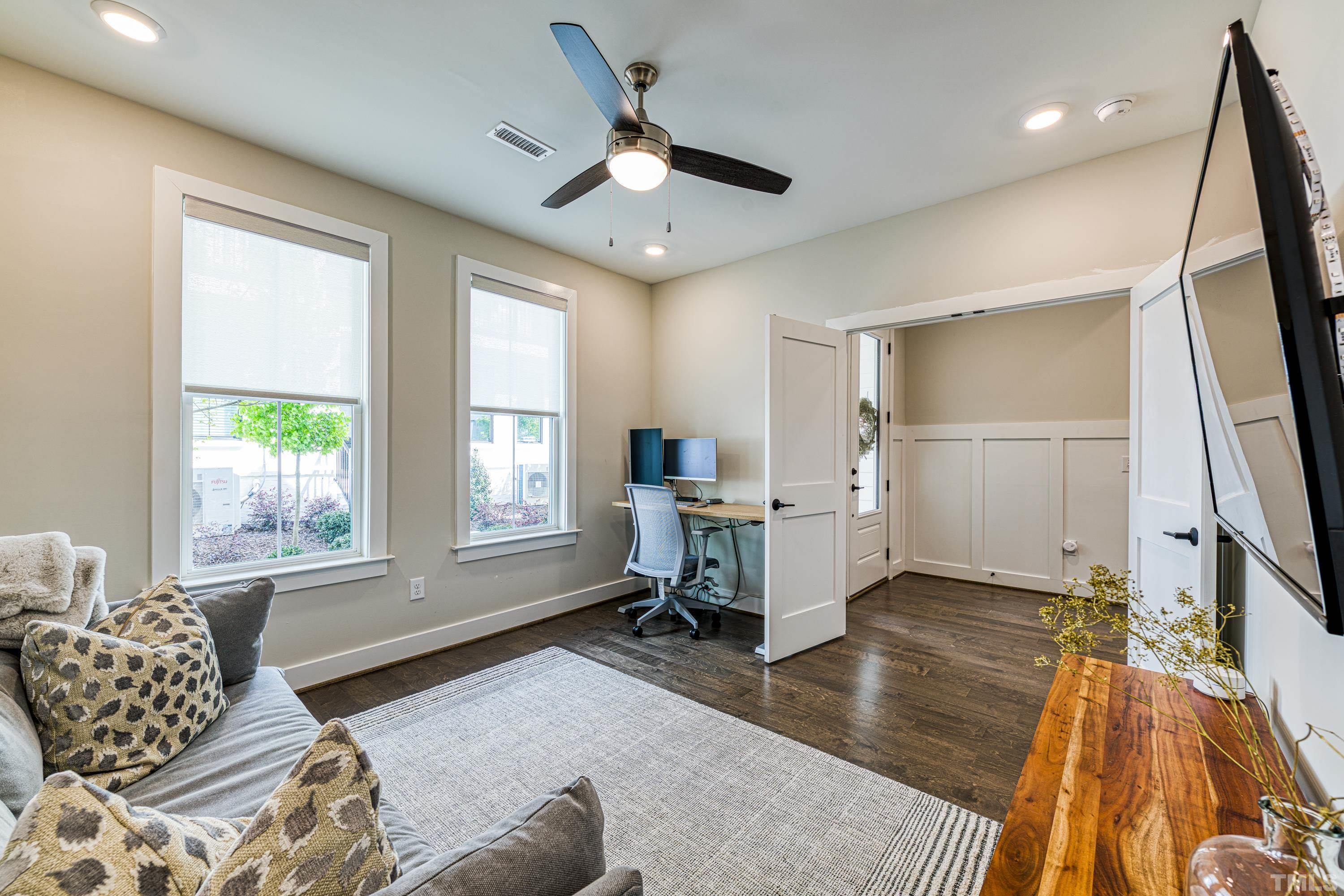 401 Bryan Pointe Drive, Unit 103 Raleigh, NC 27608 - Photo 5 of 33 a living room with furniture and a window