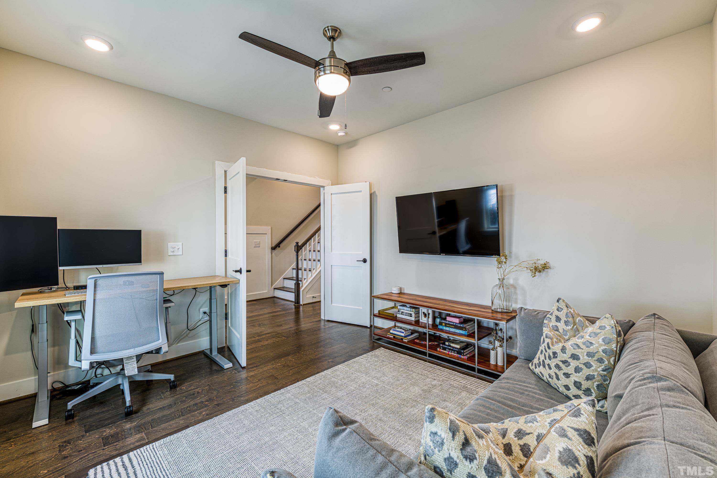 401 Bryan Pointe Drive, Unit 103 Raleigh, NC 27608 - Photo 6 of 33 a living room with furniture and a flat screen tv