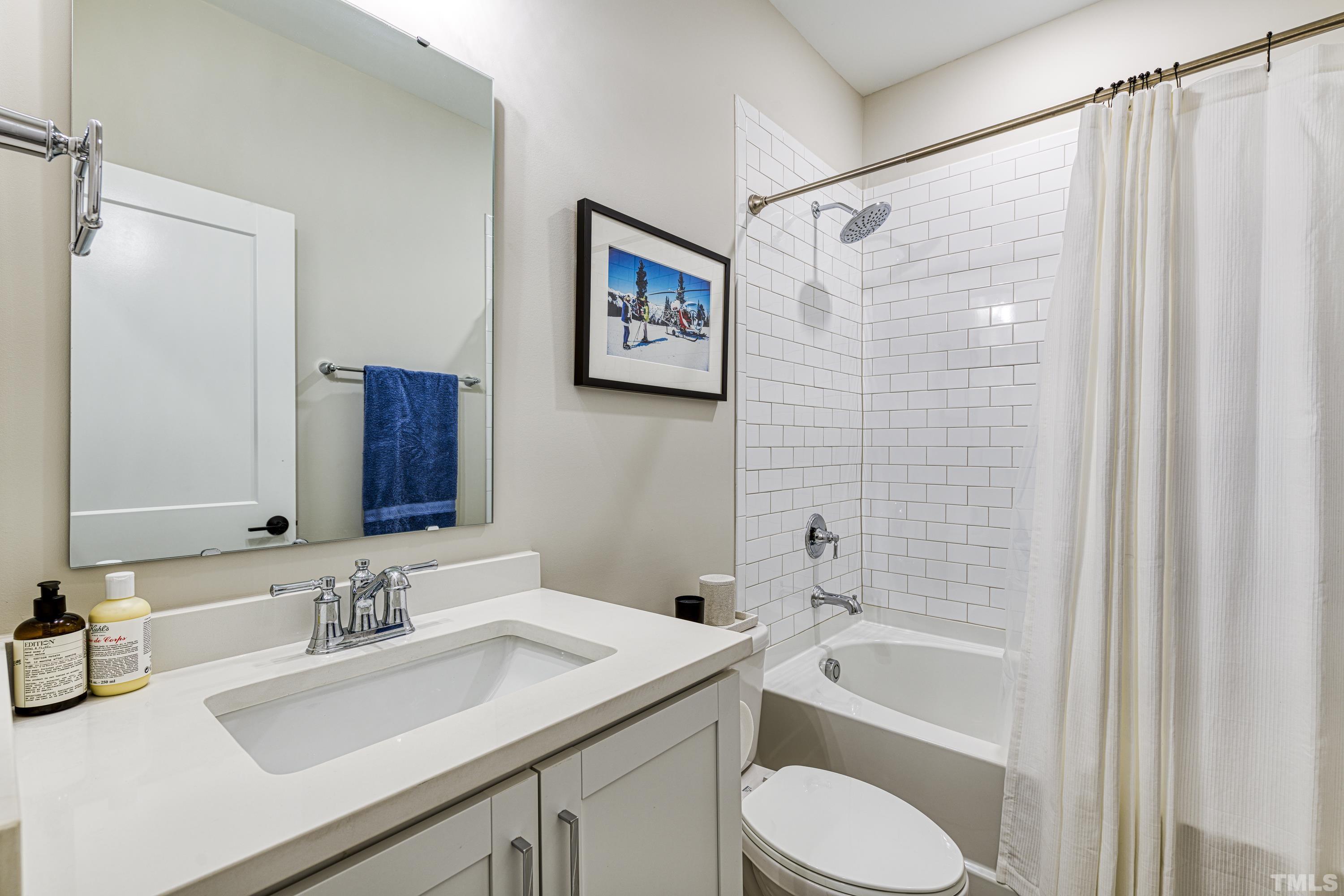 401 Bryan Pointe Drive, Unit 103 Raleigh, NC 27608 - Photo 8 of 33 a bathroom with a sink toilet and shower