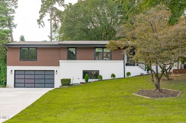 a front view of a house with a yard and garage