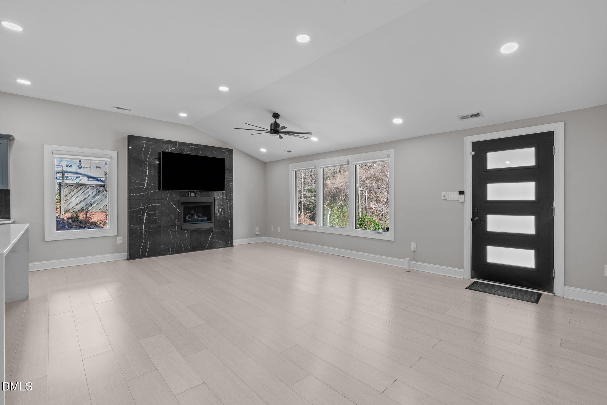 3513 Brook Drive Raleigh, NC 27609 - Photo 5 of 61 an empty room with windows and flat screen tv