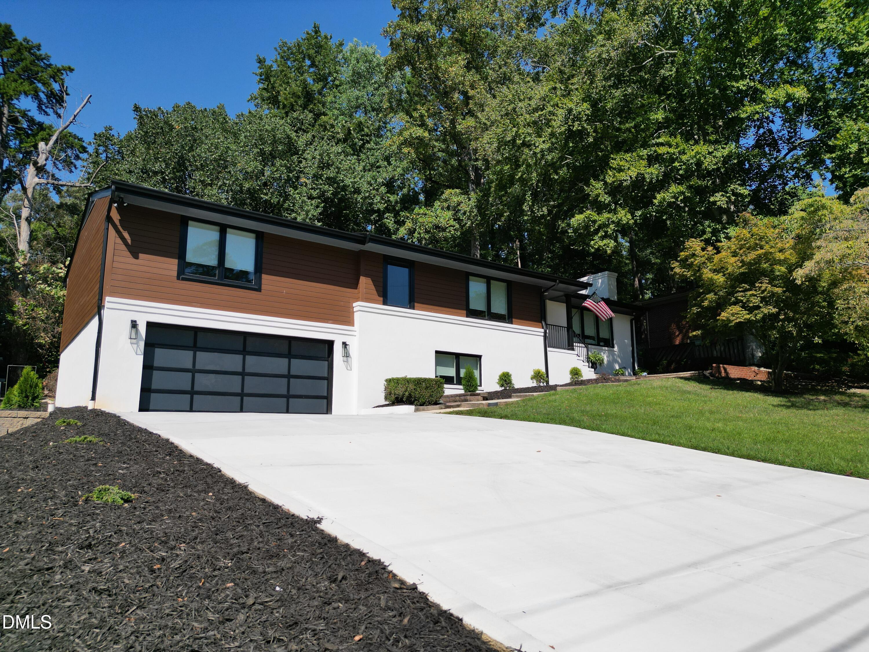 3513 Brook Drive Raleigh, NC 27609 - Photo 60 of 61 a front view of a house with a yard and garage
