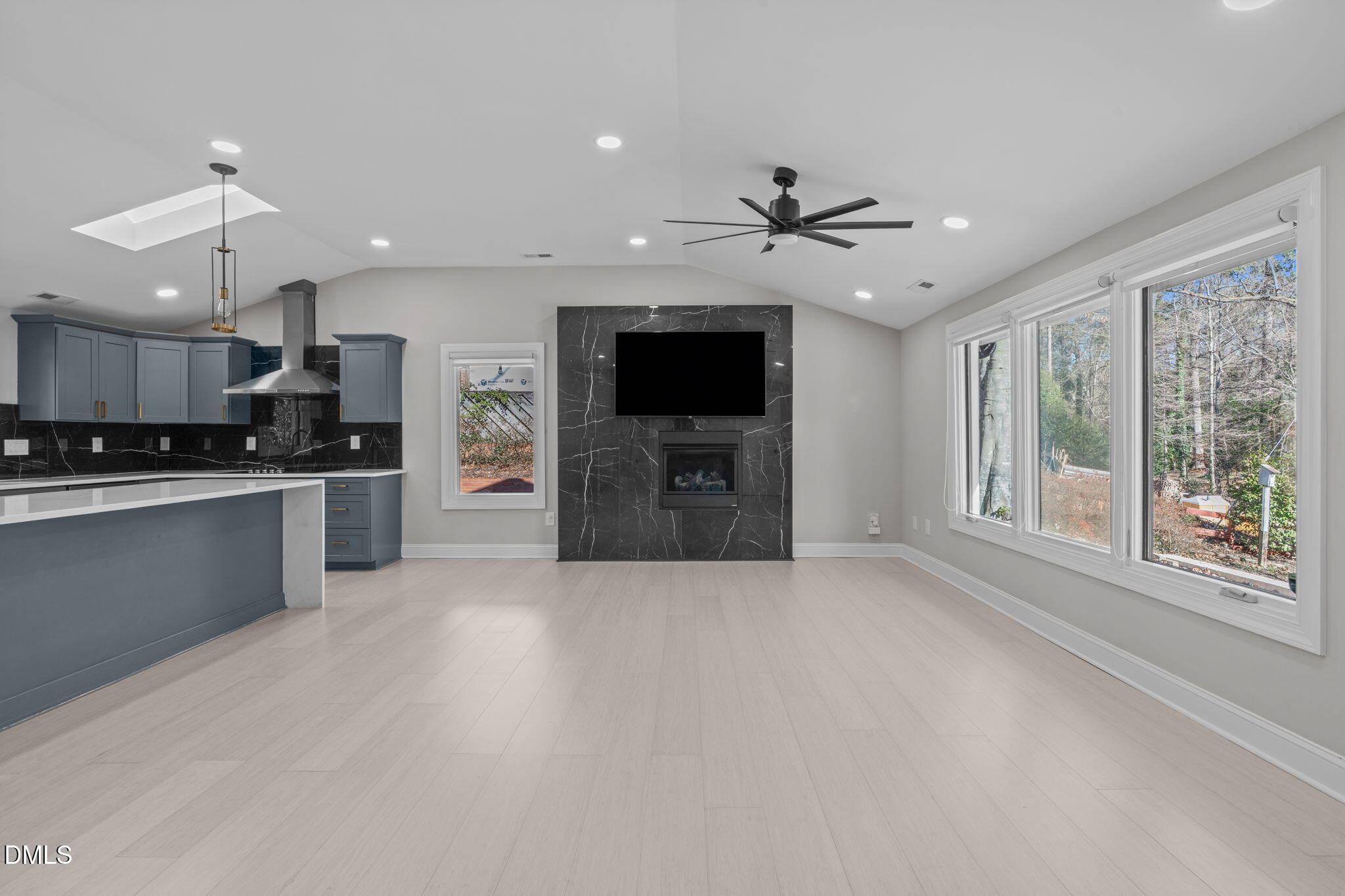 3513 Brook Drive Raleigh, NC 27609 - Photo 7 of 61 a view of a kitchen with a stove cabinets a ceiling fan and wooden floor