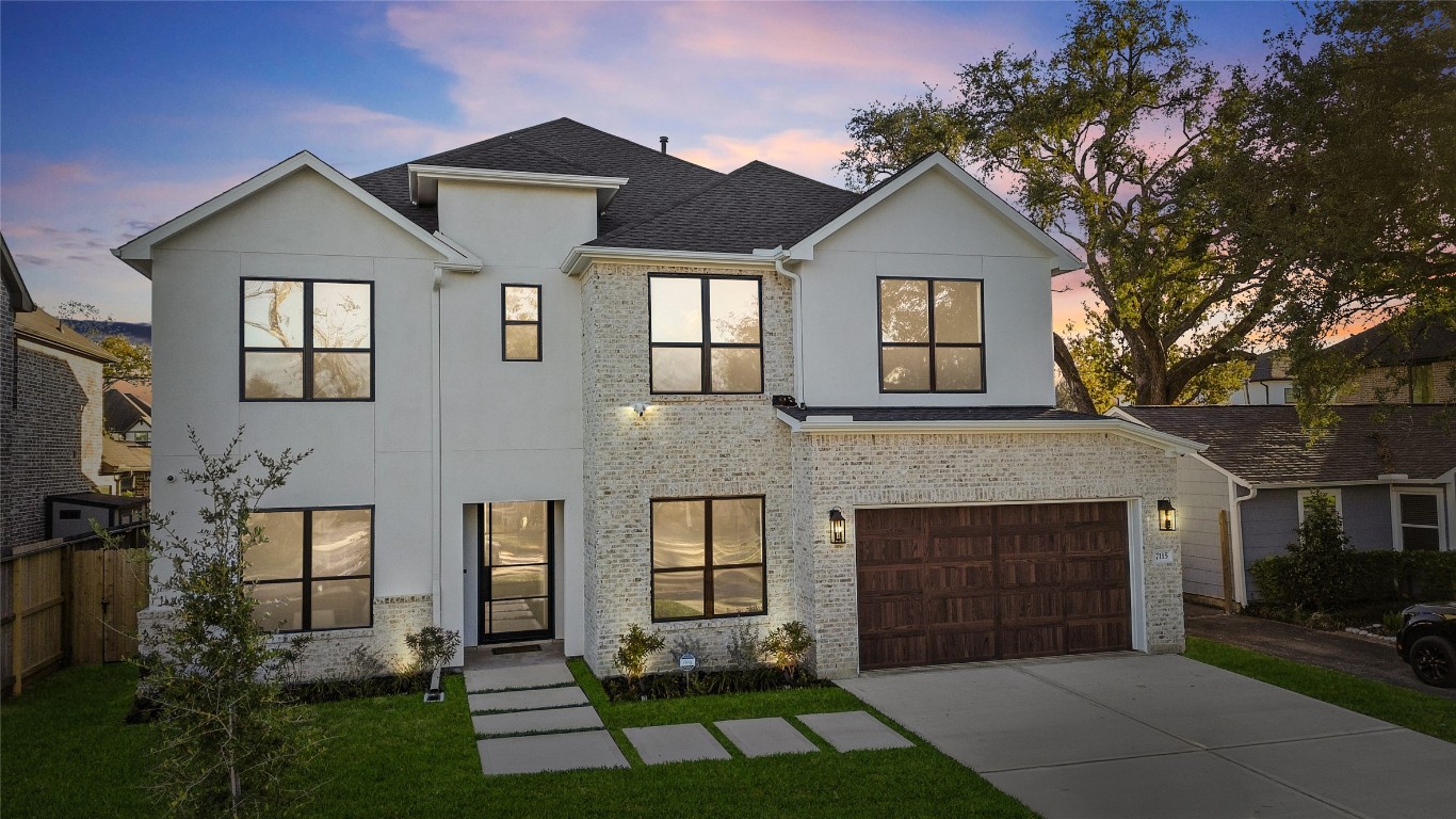 Pulling up, you’re greeted by a wide driveway, a sleek two-car garage, and a landscaped front yard that feels polished yet welcoming—everything about the façade sets the tone for the elevated living waiting inside.