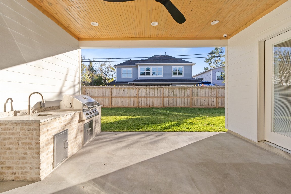 7115 Raton Street Houston, TX 77055 - Photo 14 of 49 You host effortlessly with your built-in outdoor kitchen—complete with grill, sink, and storage—so gatherings naturally flow between the kitchen, patio, and backyard.
