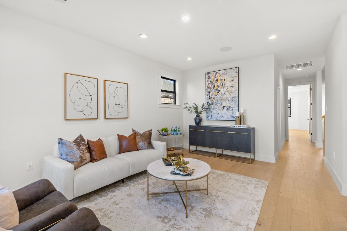 7115 Raton Street Houston, TX 77055 - Photo 15 of 49 Just beyond the hidden flex space (speakeasy/media/gym), your game room opens up into a polished yet inviting space where everything flows naturally. Styled for comfort and conversation, this area anchors the home and creates the perfect contrast to the tucked-away flex space—open, social, and ready for everyday living.