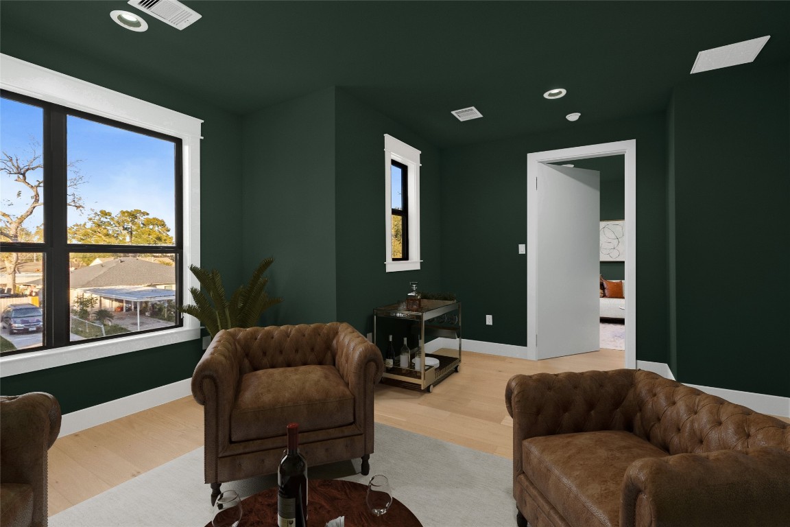 7115 Raton Street Houston, TX 77055 - Photo 22 of 49 From this angle, you get a better sense of how flexible and well-proportioned this speakeasy room truly is. Virtually staged to highlight its lounge potential, the layout easily accommodates seating, accent pieces, or a bar setup—showing how effortlessly this space adapts to your lifestyle, whether you’re entertaining or enjoying quiet downtime.