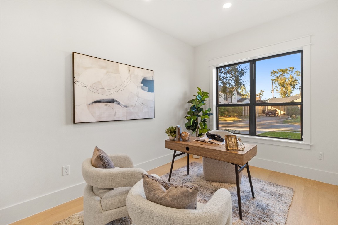 7115 Raton Street Houston, TX 77055 - Photo 23 of 49 This is where your everyday meals turn into slow, meaningful moments. Your dining room is anchored by a solid wood table beneath a soft, statement chandelier that sets the mood without overpowering the space. Large windows frame leafy neighborhood views, filling the room with natural light while keeping things calm, bright, and inviting for dinners, celebrations, or quiet mornings with coffee.