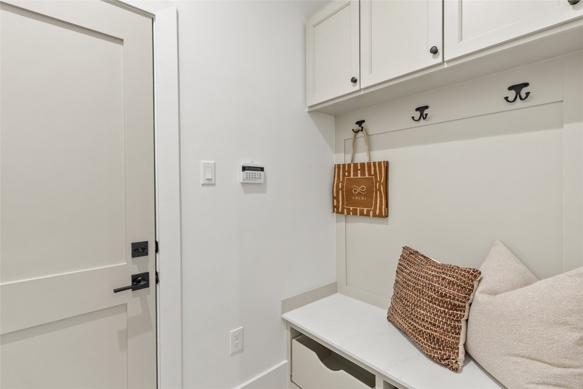 7115 Raton Street Houston, TX 77055 - Photo 26 of 49 You step inside and immediately appreciate this built-in drop zone designed to keep everyday life organized. Upper cabinets hide clutter, while hooks and a bench give you a dedicated spot for bags, shoes, and daily essentials—functional, polished, and perfectly placed off the entry.