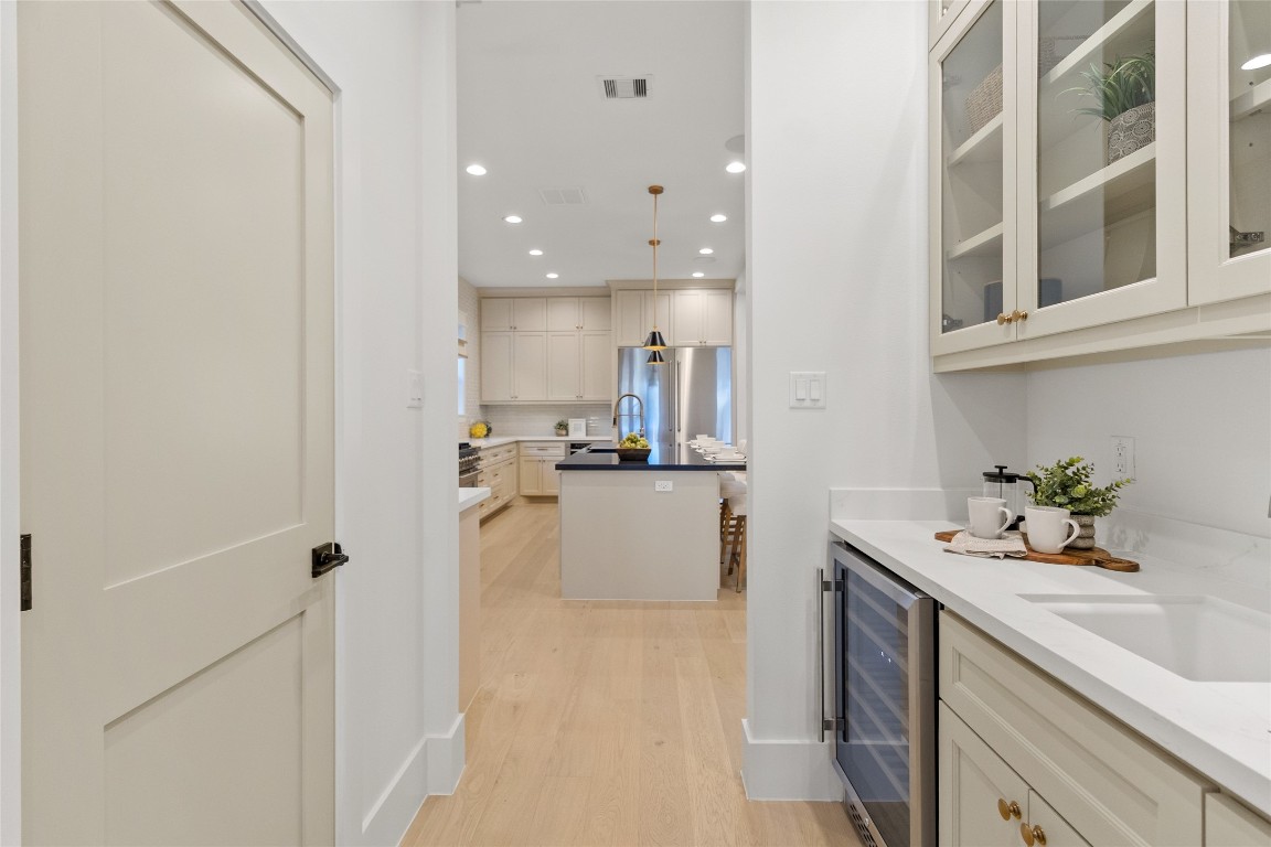 7115 Raton Street Houston, TX 77055 - Photo 29 of 49 This built-in wet bar adds a polished, entertaining-ready touch right where you want it. With sleek countertops, custom cabinetry, and space for your favorite glassware and beverages, it’s perfect for hosting, unwinding after a long day, or grabbing a quick refreshment without stepping away from the action.