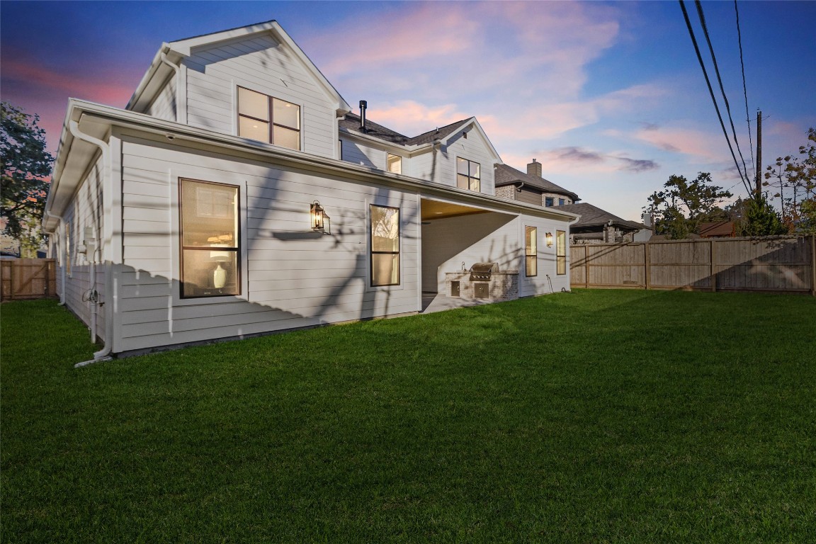 7115 Raton Street Houston, TX 77055 - Photo 35 of 49 Out back, you’ve got a spacious, fully fenced yard with room to relax, play, or entertain. The covered patio is already set up for outdoor dinners or weekend grilling, making this space feel like a natural extension of your living area.