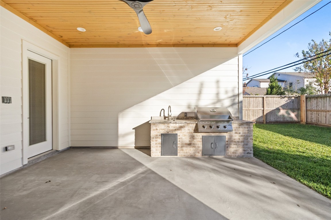 7115 Raton Street Houston, TX 77055 - Photo 40 of 49 Your covered patio extends your living space, featuring a warm wood-plank ceiling, recessed lighting, and a ceiling fan that make outdoor lounging comfortable in every season.