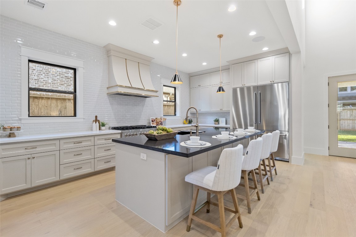 7115 Raton Street Houston, TX 77055 - Photo 5 of 49 This is the kitchen you’ve been waiting for — a chef-worthy layout with a professional gas range, custom vent hood, and expansive counter space that makes cooking feel like an experience, not a chore. Your full-height cabinetry offers abundant storage while keeping the look clean and timeless, and the seamless flow from prep space to island sink makes entertaining second nature. From weeknight dinners to holiday spreads, this kitchen is built to handle it all — beautifully.
