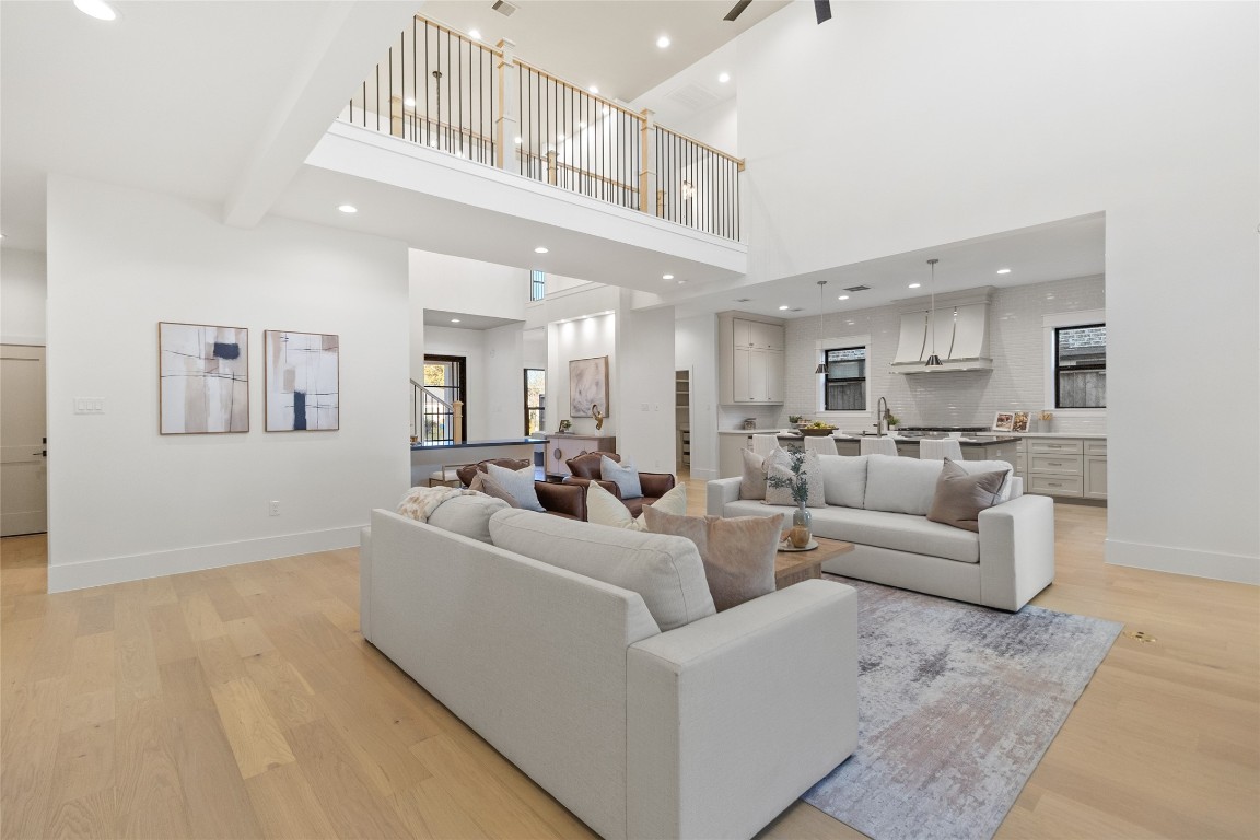 7115 Raton Street Houston, TX 77055 - Photo 6 of 49 From this angle, your dramatic floor-to-ceiling brick fireplace becomes the focal point, anchoring the living space while framing sightlines straight into the kitchen. Whether you’re hosting friends or enjoying a quiet night in, everything stays connected without sacrificing visual impact.