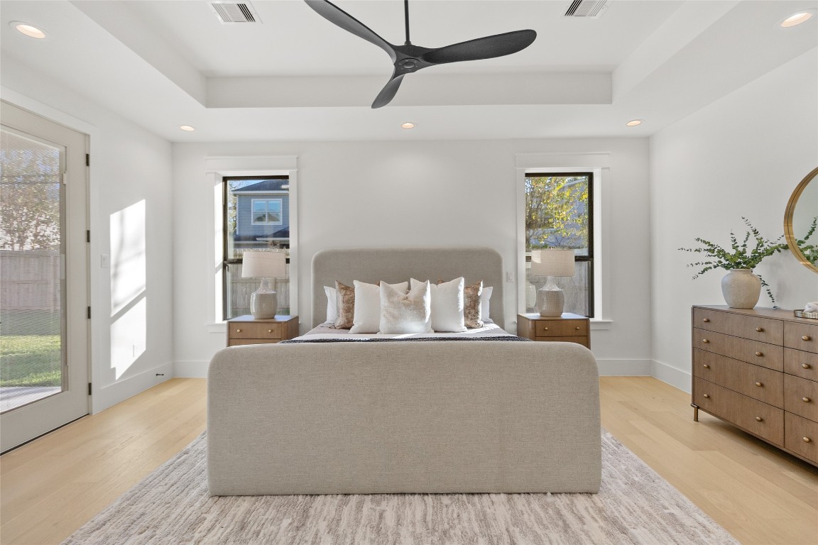 7115 Raton Street Houston, TX 77055 - Photo 10 of 49 Your primary bedroom is designed to feel like a retreat, centered around a spacious layout that easily fits a king-sized bed while still leaving room to breathe. Tall ceilings, recessed lighting, and oversized windows create a peaceful, hotel-like atmosphere that makes winding down feel natural.