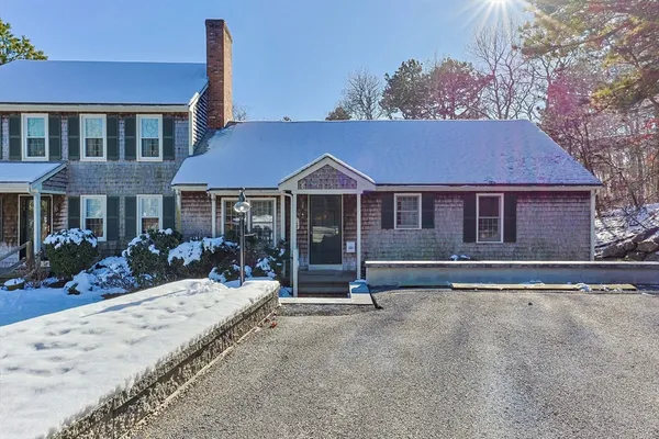 a front view of a house with a yard outdoor seating and garage