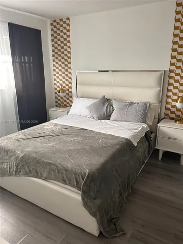 a bedroom with a bed and a couch