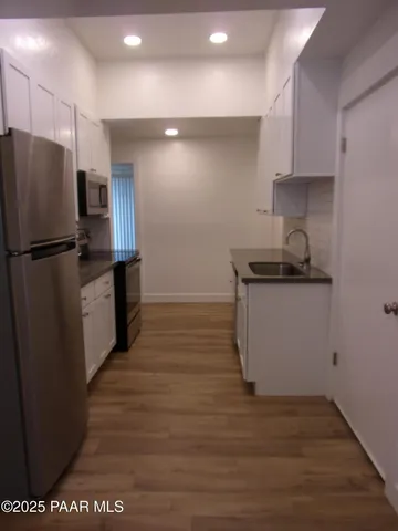 a kitchen with a refrigerator and a sink