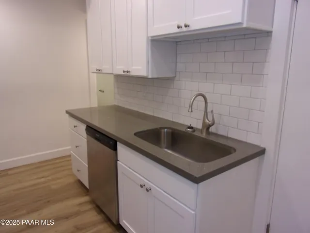 a kitchen with a sink and cabinets