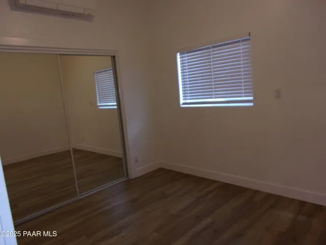 a view of storage and utility room with wooden floor