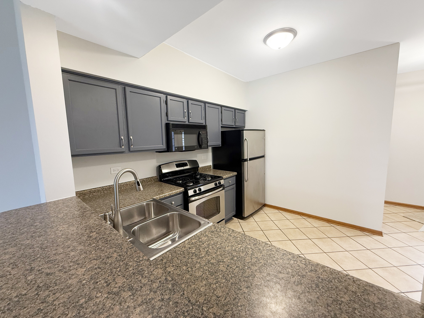 440 Mill Street Batavia, IL 60510 - Photo 4 of 17 a kitchen with stainless steel appliances granite countertop a stove a sink and a microwave