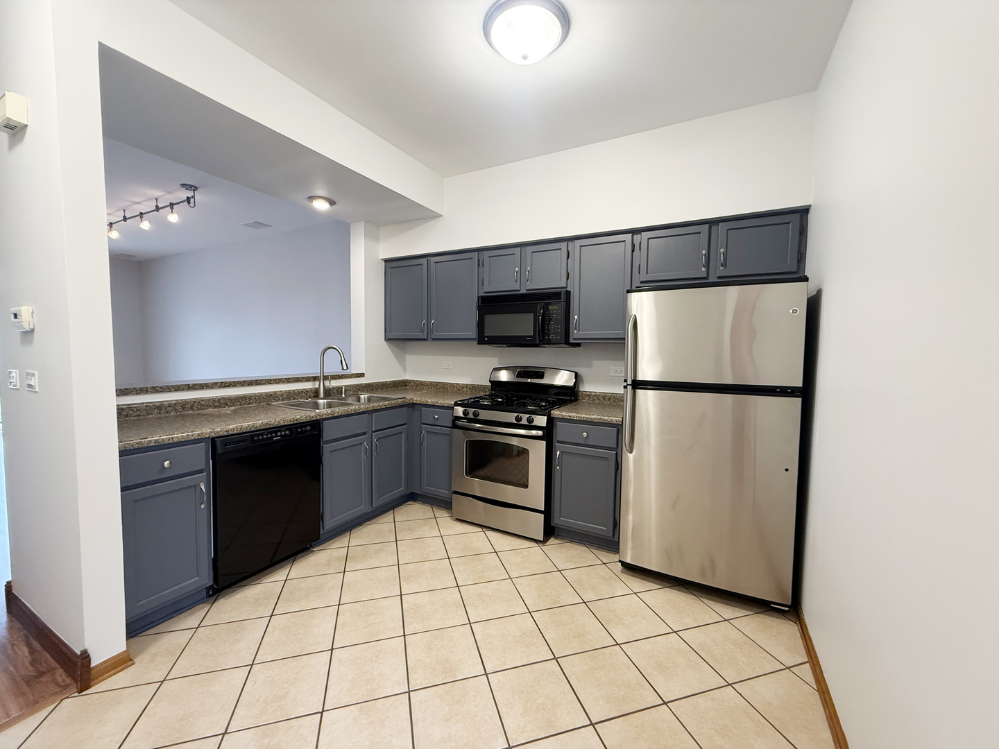 440 Mill Street Batavia, IL 60510 - Photo 5 of 17 a kitchen with stainless steel appliances granite countertop a refrigerator stove top oven and sink