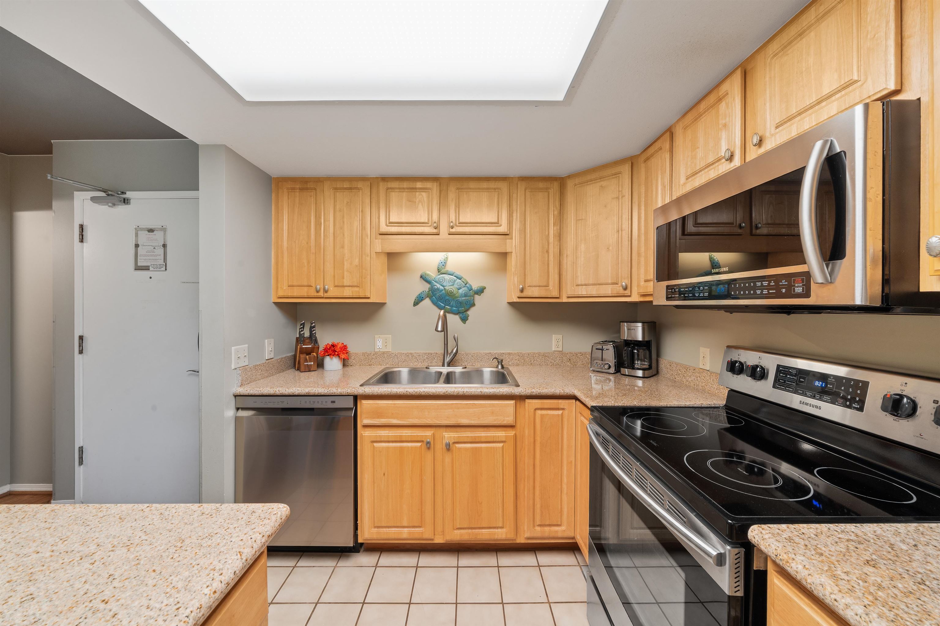 2575 South Kihei Road, Unit H207 Kihei, HI 96753 - Photo 13 of 31 a kitchen with stainless steel appliances a stove a sink a refrigerator cabinets and a window