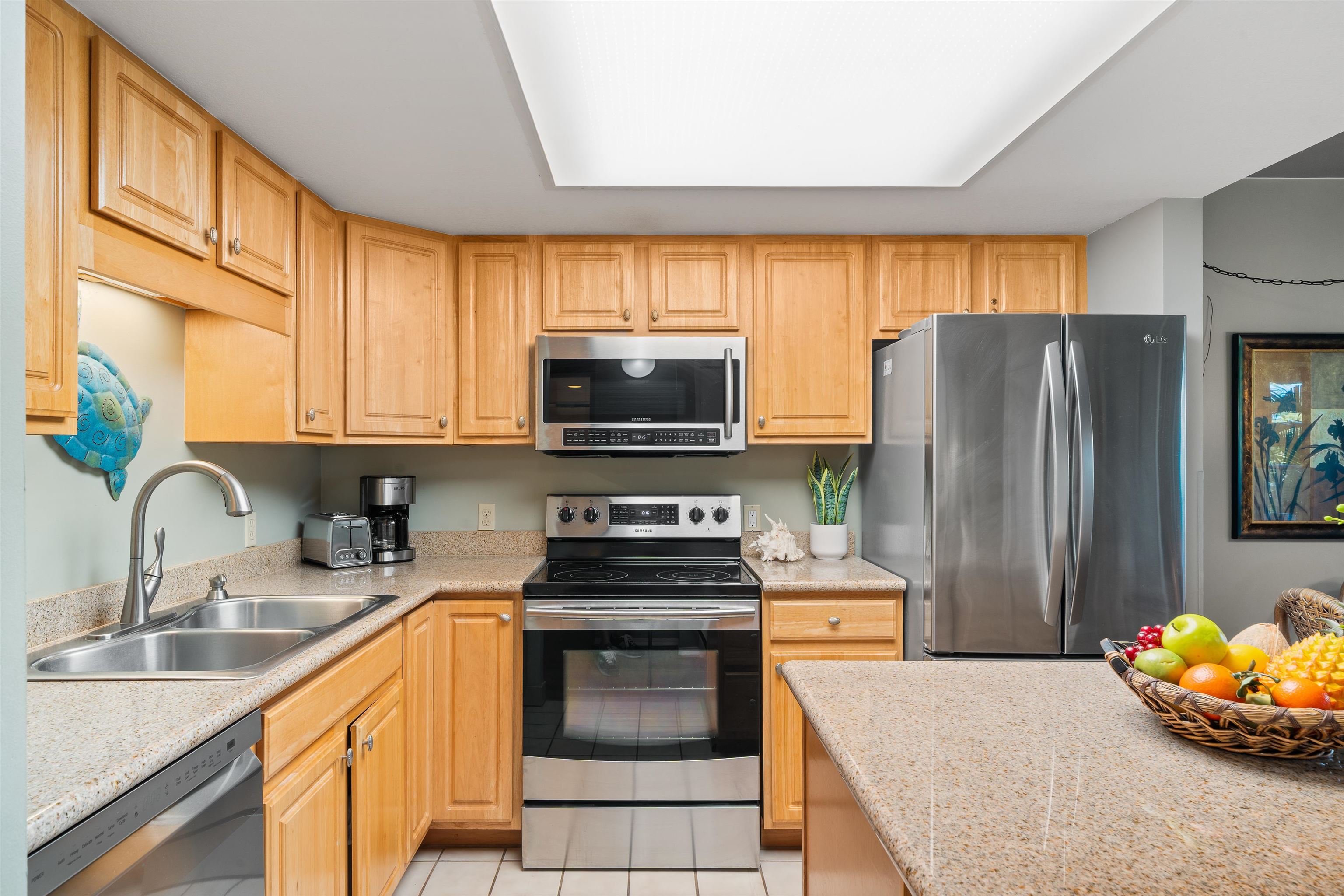 2575 South Kihei Road, Unit H207 Kihei, HI 96753 - Photo 3 of 31 a kitchen with stainless steel appliances a stove sink microwave and refrigerator