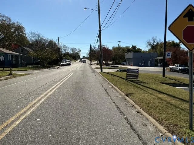 a view of a street with houses on both side of it