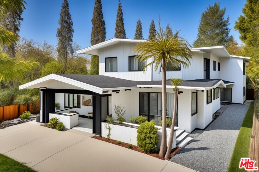 a view of a house with yard and sitting area
