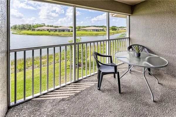 a view of a porch with furniture and a yard