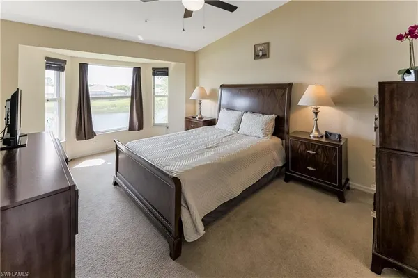 a bedroom with a bed and a night stand