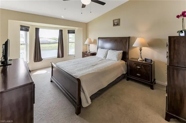 a bedroom with a bed and a night stand