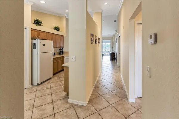 a view of a hallway with wooden floor and a living room