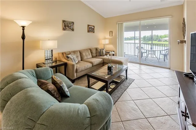 a living room with furniture and a lamp