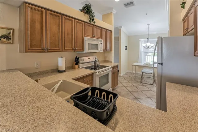 a kitchen with granite countertop a stove and a refrigerator