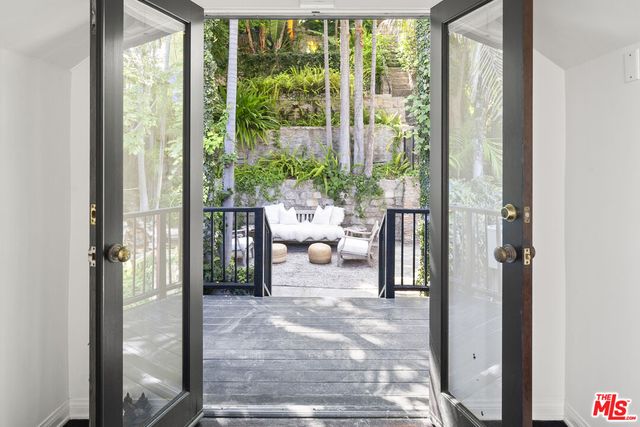 a view of a backyard with table and chairs potted plants