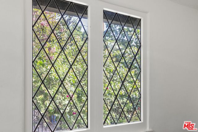 a view of a dining room and livingroom with furniture wooden floor and a rug