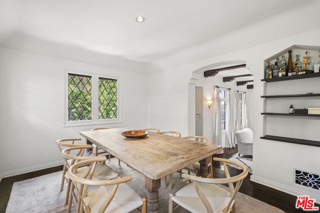 a kitchen with white cabinets and appliances