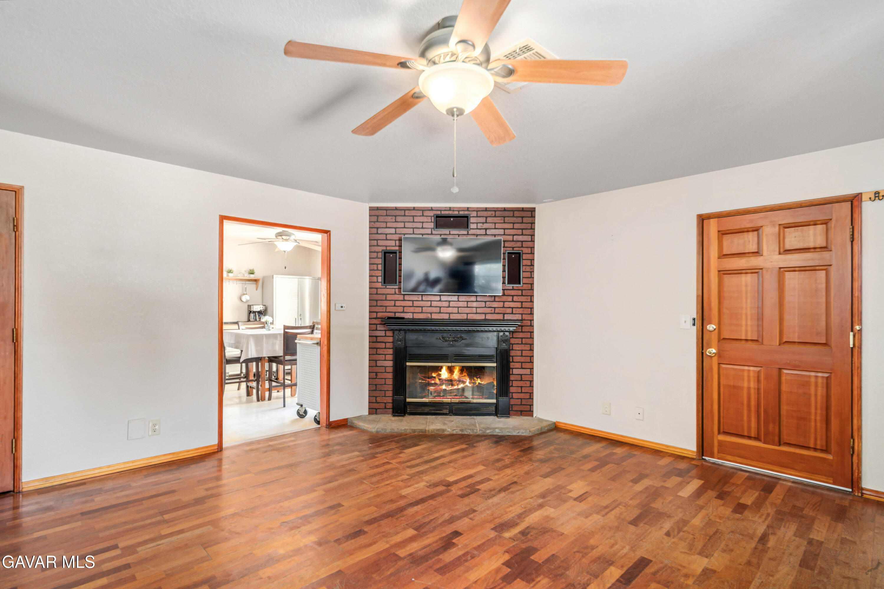43230 Lookabout Road Lake Hughes, CA 93532 - Photo 4 of 35 an empty room with windows fireplace and fan