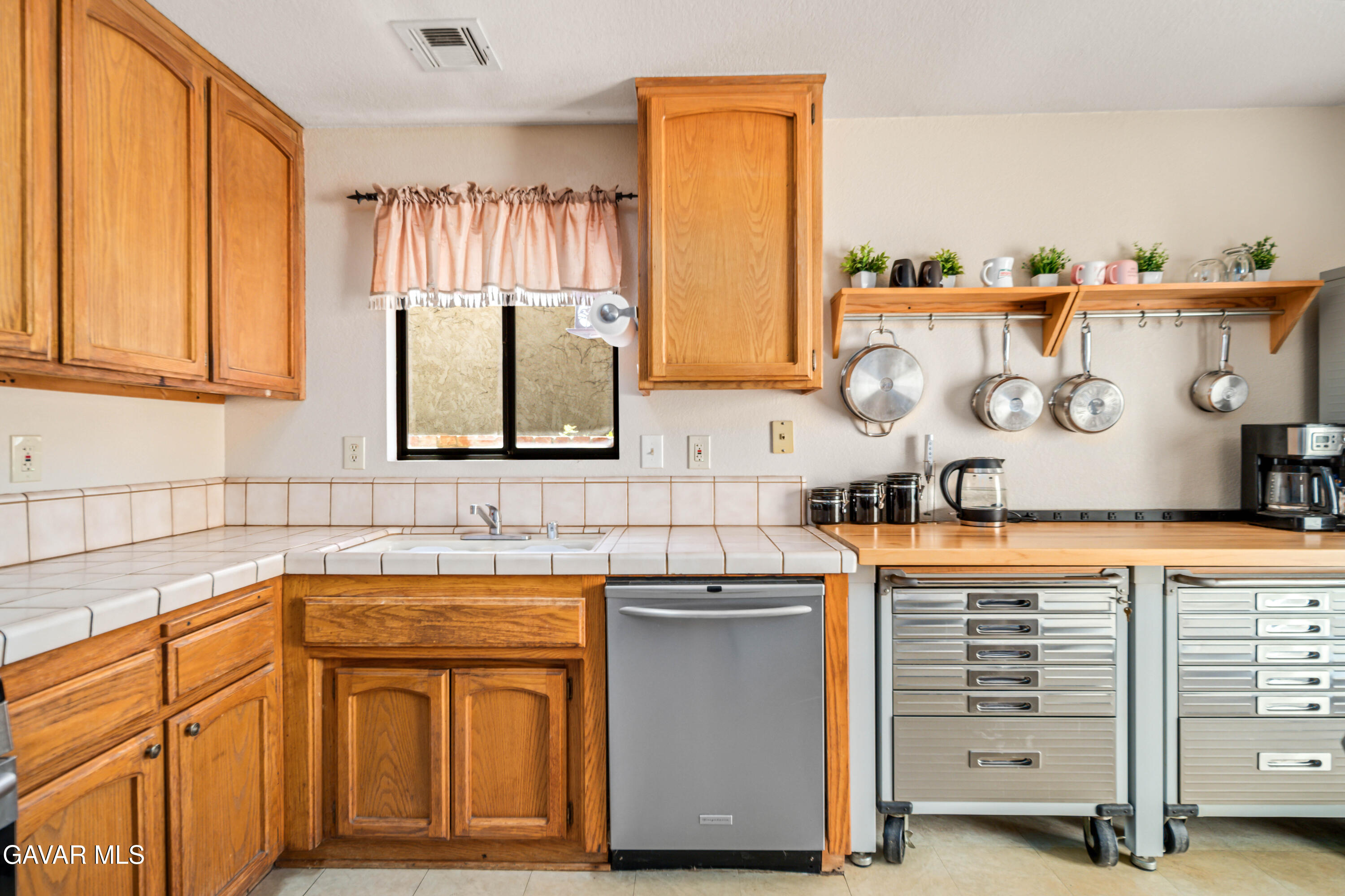 43230 Lookabout Road Lake Hughes, CA 93532 - Photo 6 of 35 a kitchen with stainless steel appliances granite countertop a sink and cabinets with wooden floor