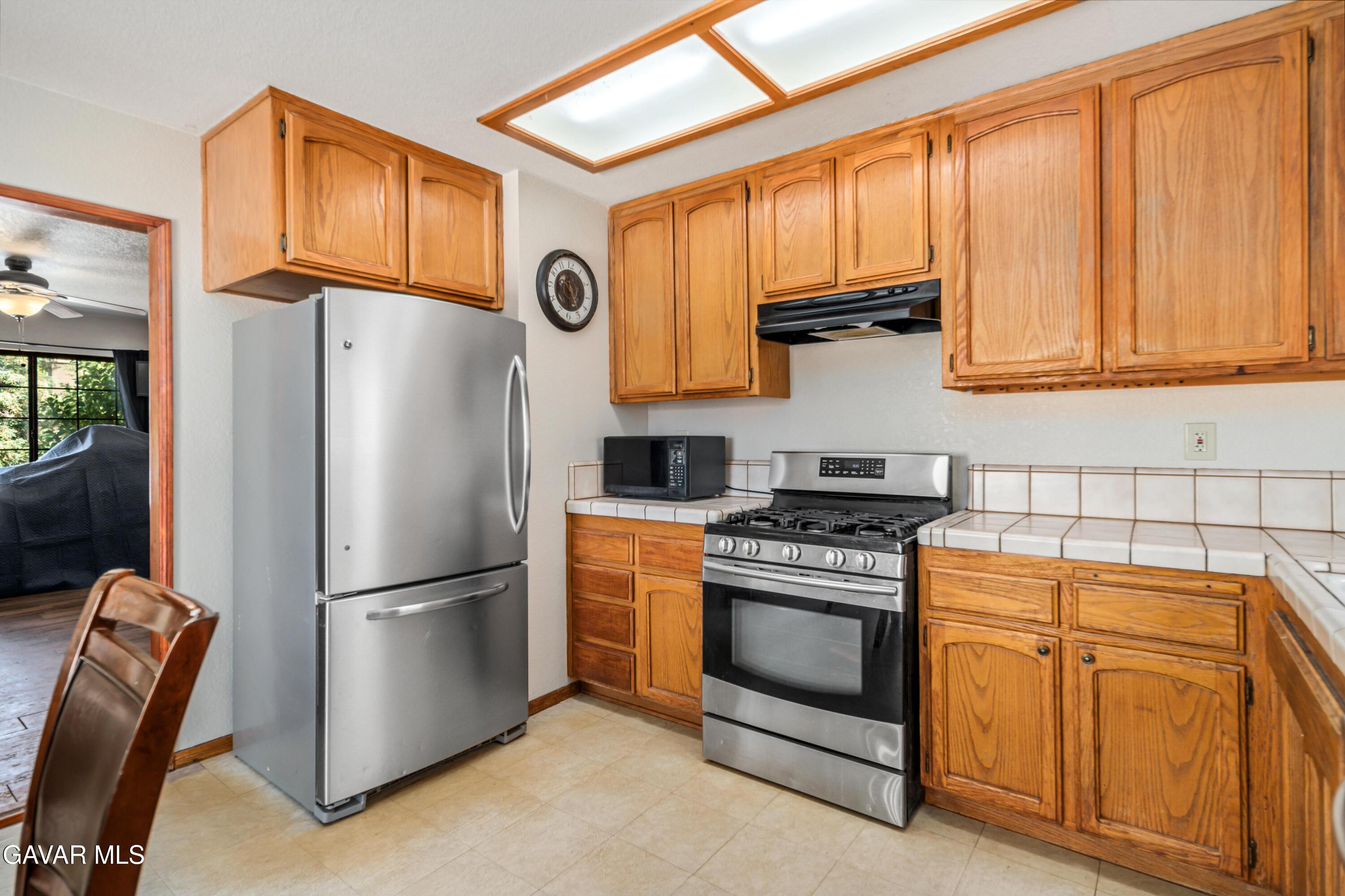 43230 Lookabout Road Lake Hughes, CA 93532 - Photo 8 of 35 a kitchen with stainless steel appliances granite countertop a refrigerator stove and sink