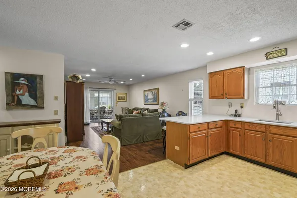 a large kitchen with kitchen island a sink stainless steel appliances and furniture