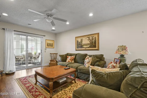 a living room with furniture a rug and a large window